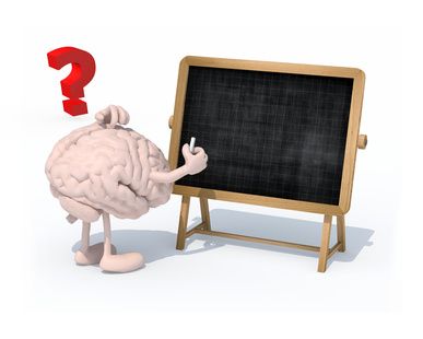 brain with arms, legs and chalk on hand in front of blackboard
